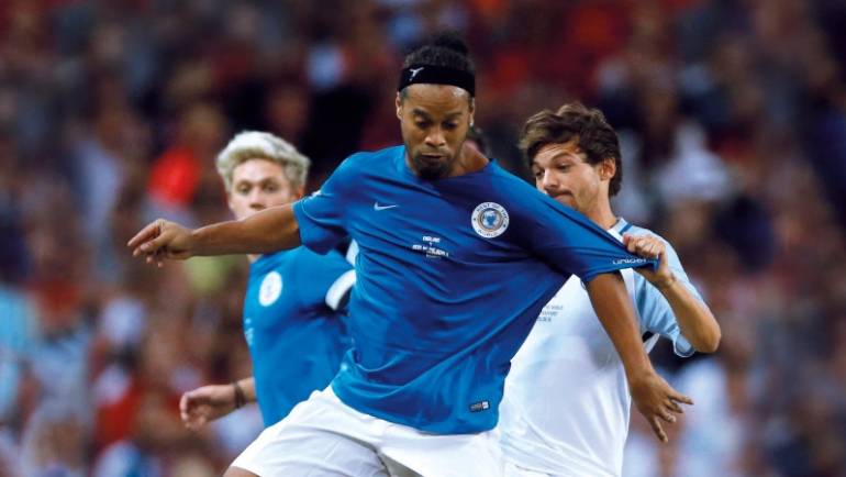 Louis Tomlinson recalls the time Ronaldinho tried to nutmeg him: ‘There’s a sick picture’