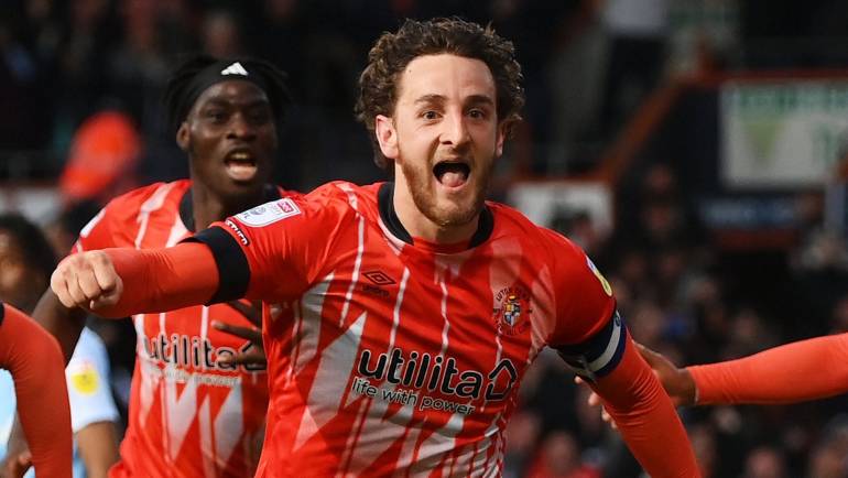 Luton captain Tom Lockyer celebrates from hospital bed with family after penalty shootout win seals return to Premier League