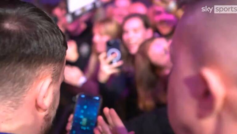 Luke Littler opens another EA FC Pack during walk-on at Premier League Darts event in Exeter